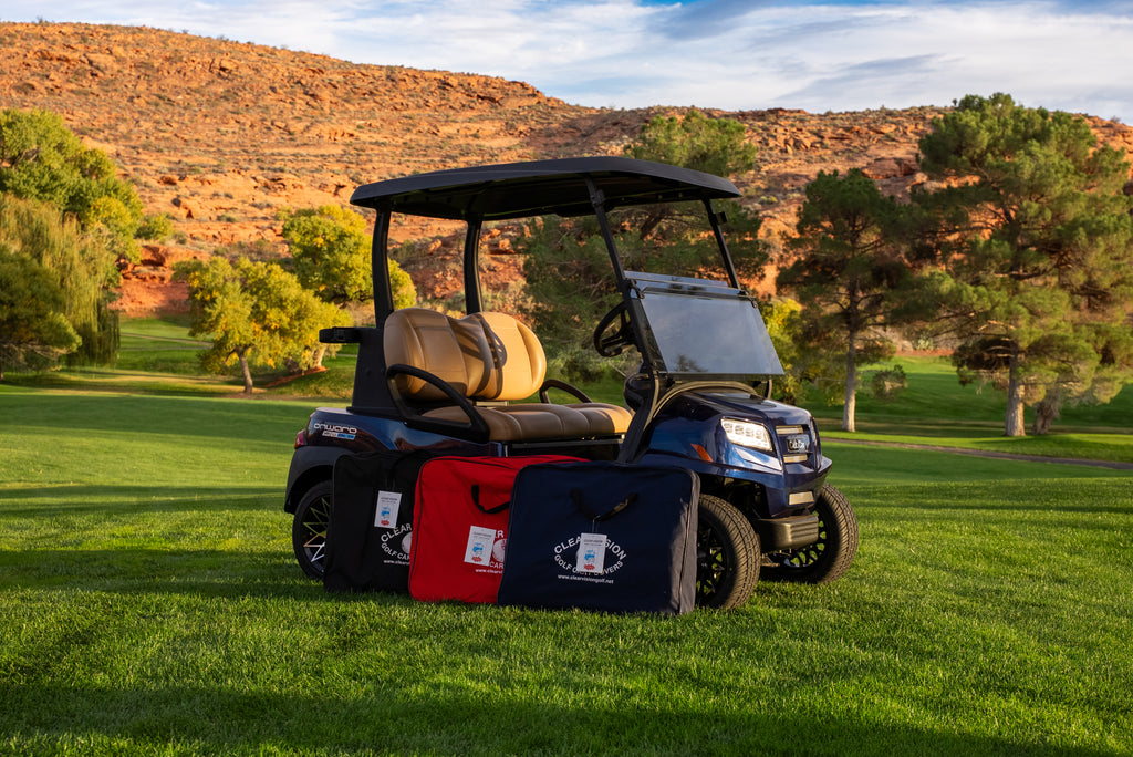 Clear Vision portable carrying cases in Black, Red, and Navy beside a golf cart