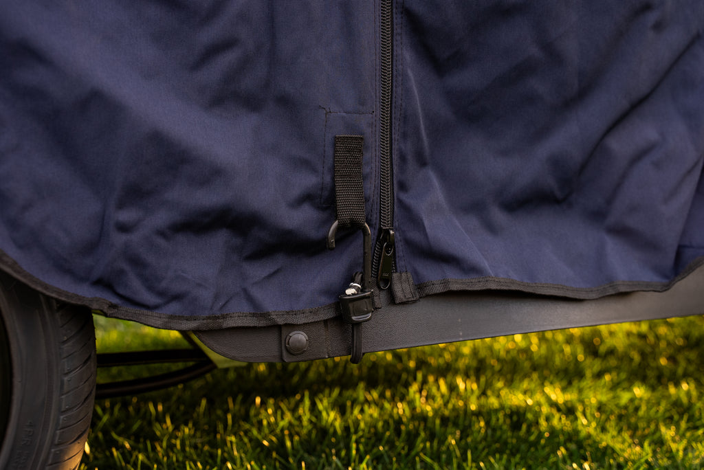 Close-up of heavy-duty bungee hook securing Navy Clear Vision cover to cart frame