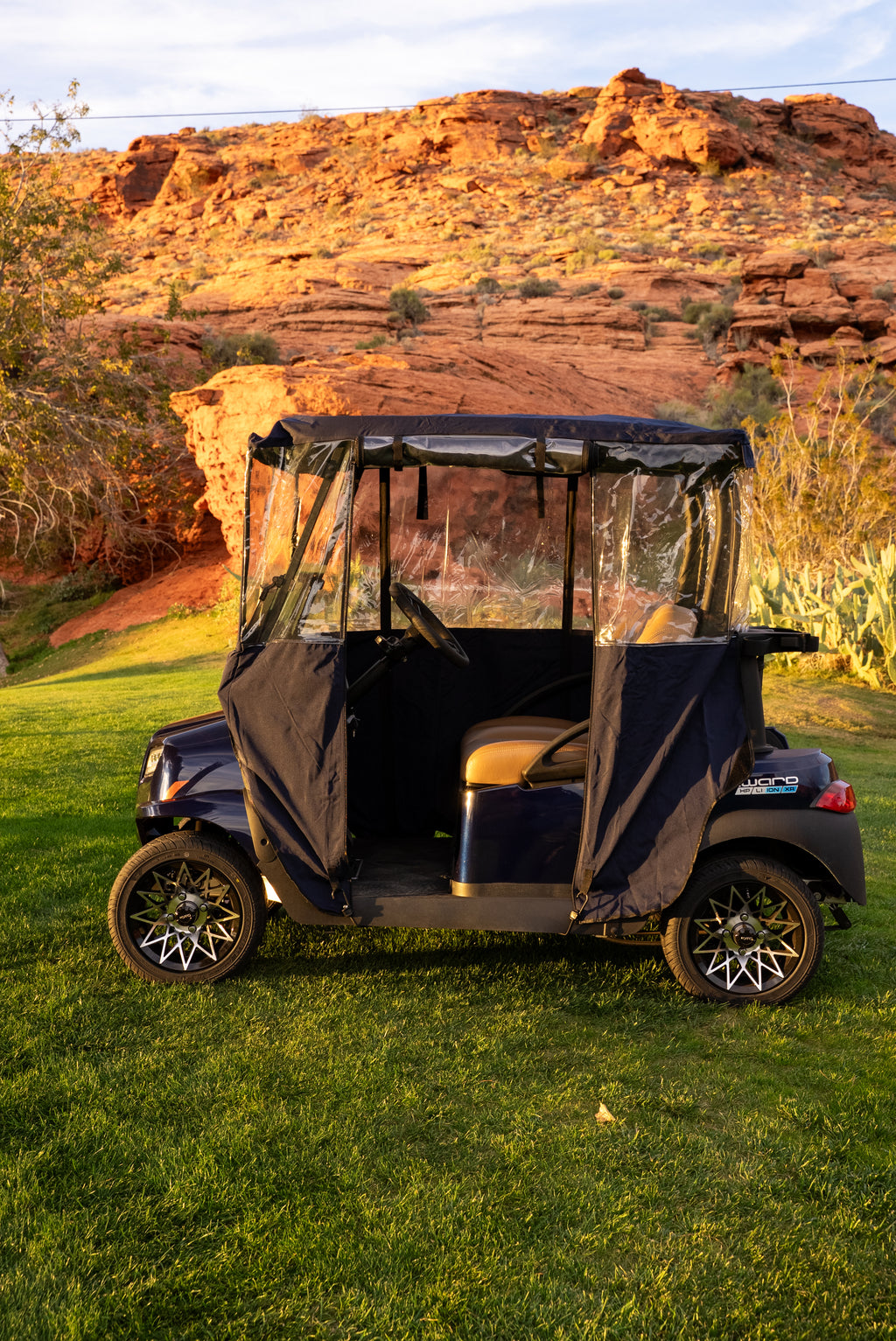 Navy Clear Vision cover with side panels pulled open for entry on desert course