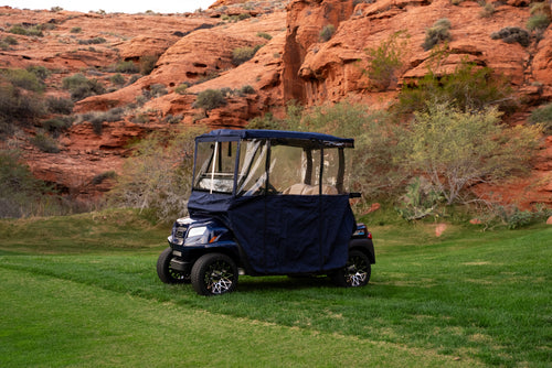 Navy Clear Vision Golf Cart Cover on a golf cart in desert red-rock landscape