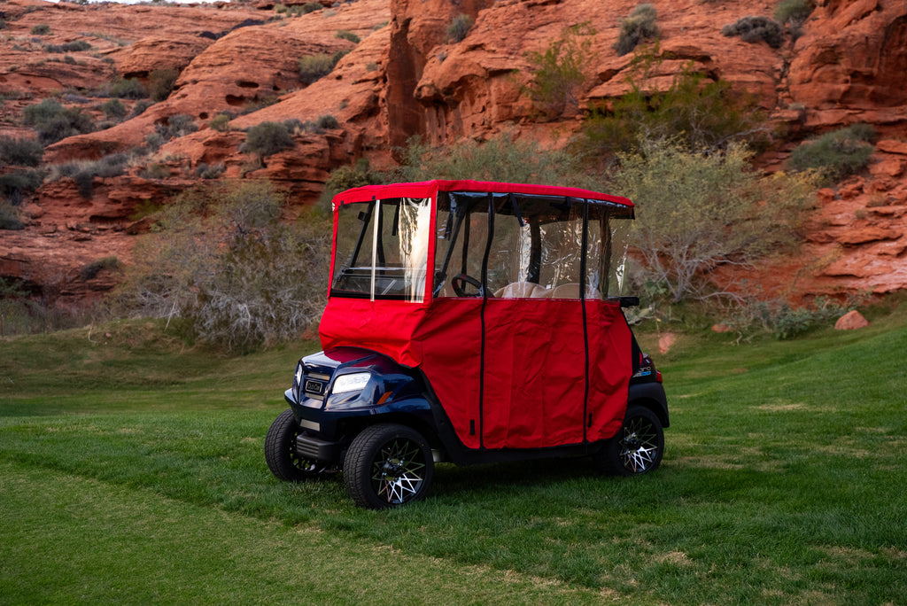 Red Clear Vision cover fully installed on navy cart with canyon backdrop