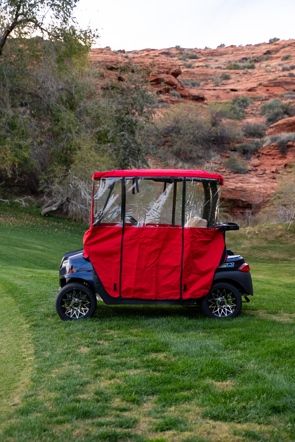 Side profile of Red Clear Vision Golf Cart Cover with clear side windows