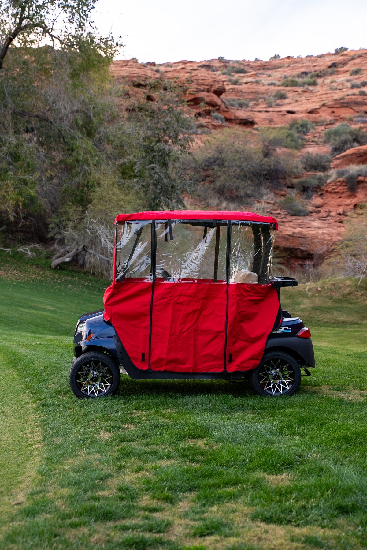 Side profile of Red Clear Vision Golf Cart Cover with clear side windows